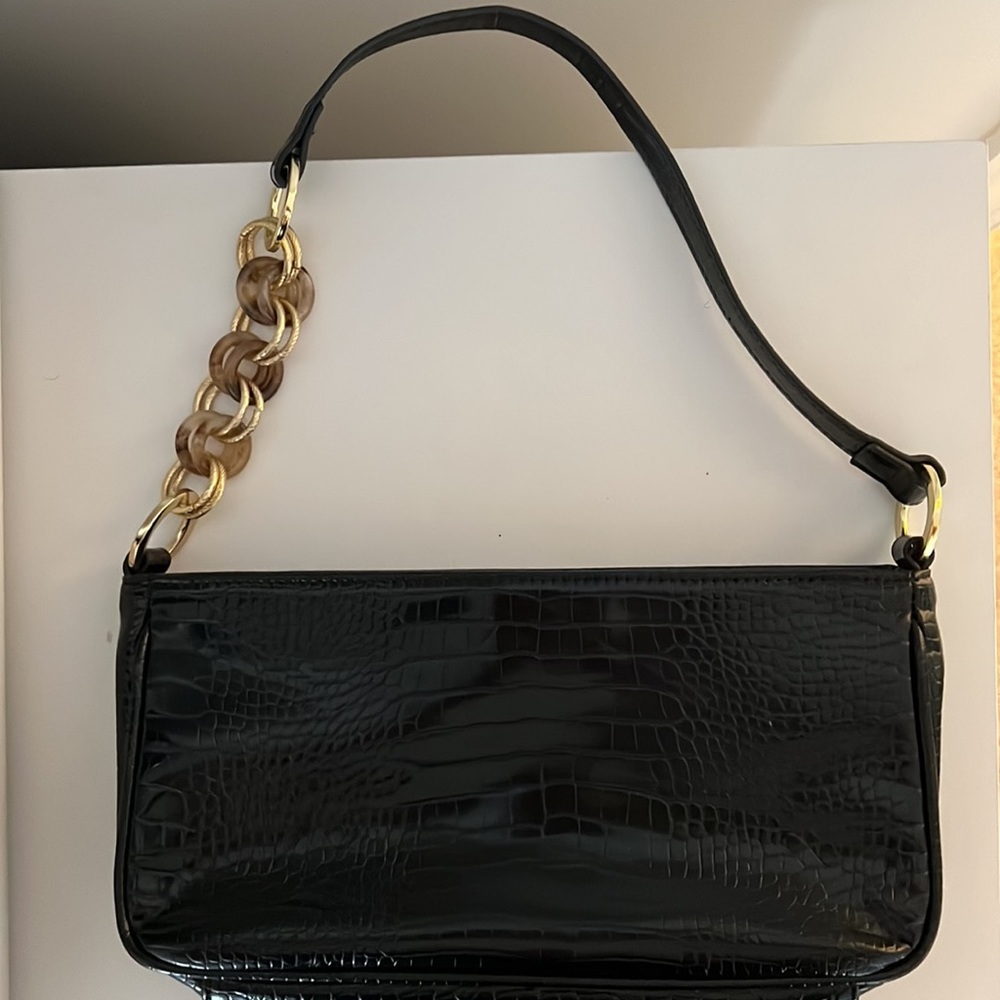 Black crocodile pattern shoulder bag with gold accents on the handle